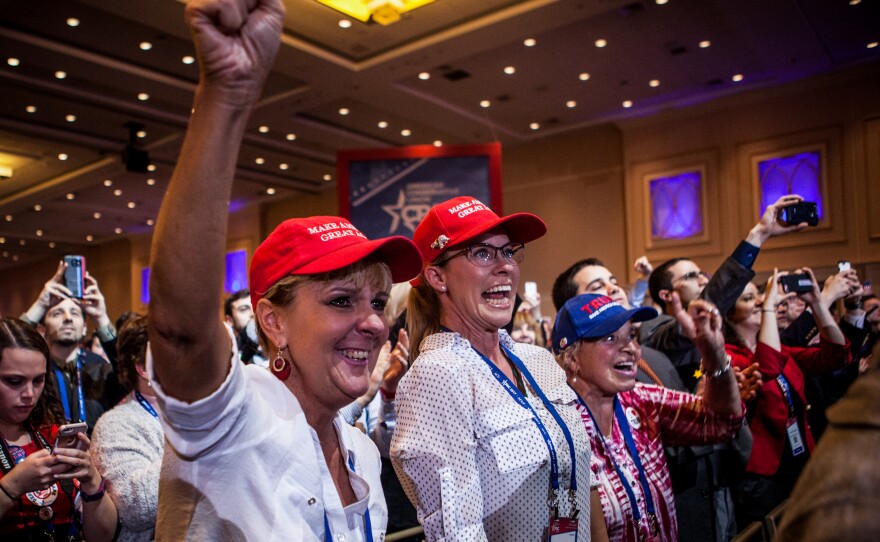 CPAC attendees cheer as President Trump speaks on the last morning of the conference.
