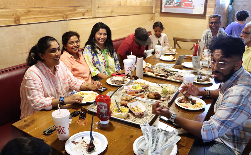 Areeba Ali (third from left) eats at Kafi BBQ with family in Irving, Texas.