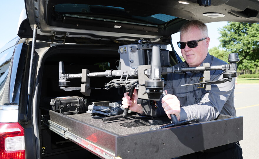 Chief Warrant Officer Kevin Fennessy lifts an Ocean County Sheriff's Office DJI Matrice 300 RTK drone out of the custom-built bed of a department SUV at Robert J. Miller Airpark on Sept. 4.