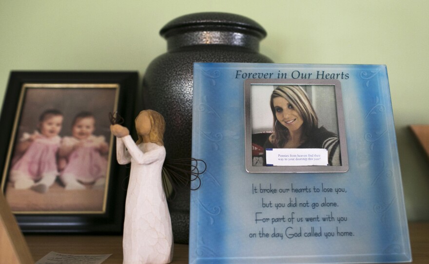 Photos and an urn of ashes to remember Chrystina Carey, Beth Carey's twin sister who died of a drug overdose in 2013, sit in her home in Marion.