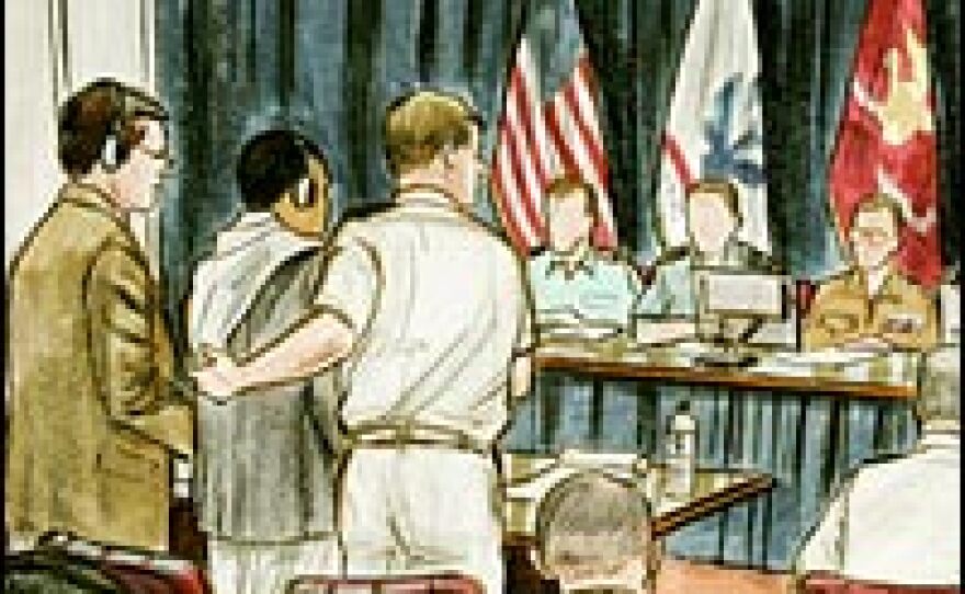 Salim Ahmed Hamdan, second from left, appears with appointed council Lt. Cmdr. Charles Swift, third from left, during a preliminary hearing at Guantanamo Bay, Cuba, Aug. 24, 2004.