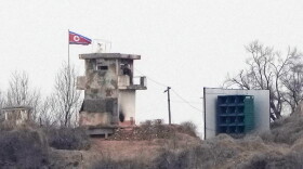FILE - A soldier stands at a North Korean military guard post next to loudspeakers, seen from Paju, South Korea, near the border with North Korea, on Feb. 26, 2026.