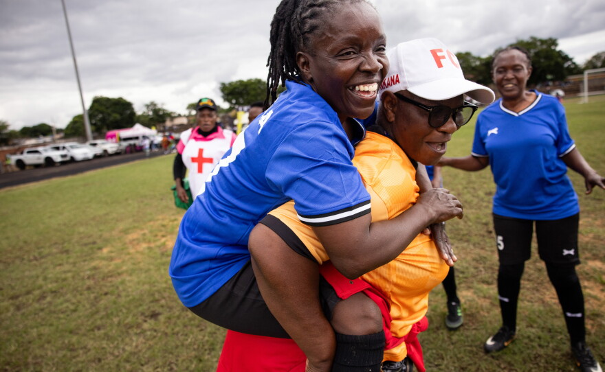 Lillian Zulu (in blue), is the captain of the Zambian team (and a professional chef). When the team bus petered out en route to the tournament, she says, "We felt we are losing it, but we didn't want to give up." Above: Zulu jumps on a teammate's back to celebrate a win.