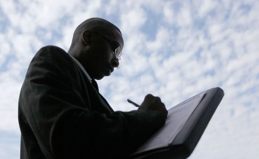 Melvin Winston fills an out application on Sept. 25 for positions at a new bar and restaurant in Detroit.