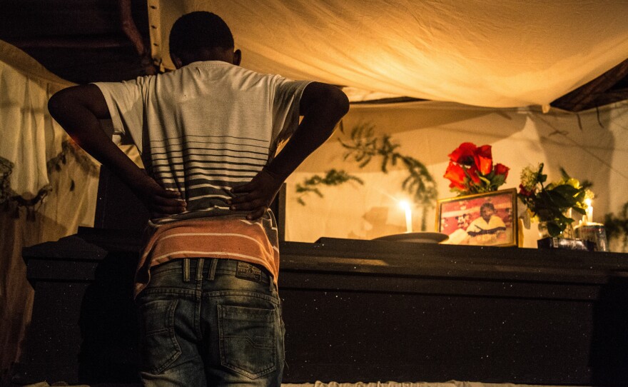A boy looks into the casket of 16-year-old Leo, who was lynched by gang members<strong>, </strong>allegedly for using slang associated with a gang in a rival neighborhood of his barrio. Leo's mother said she wanted an open casket so people could see what they did to her son. "His body was destroyed," says Ayuso.<strong> </strong>