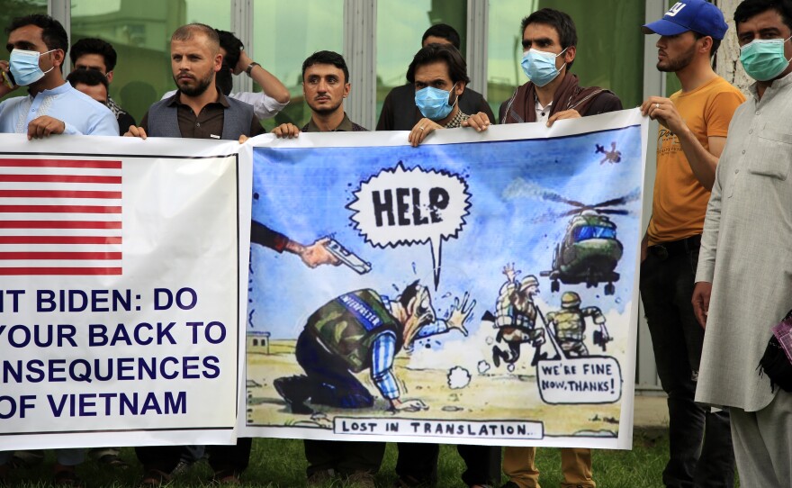 Former Afghan interpreters hold banners during a protest against the U.S. government and NATO in Kabul on April 30, 2021.
