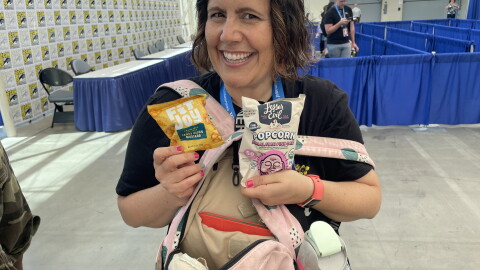 San Diego writer Lauren Marie Fleming poses with her Comic-Con survival supplies on Thursday, July 24, 2025. "I'm gluten free, so I have to bring snacks," she said.