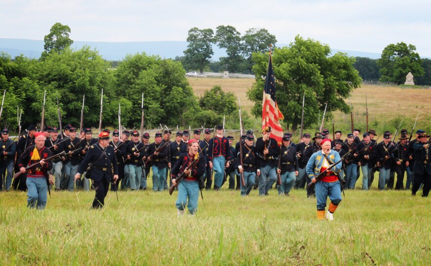 Men dressed as members of the Union infantry demonstrate battalion formations for tourists.