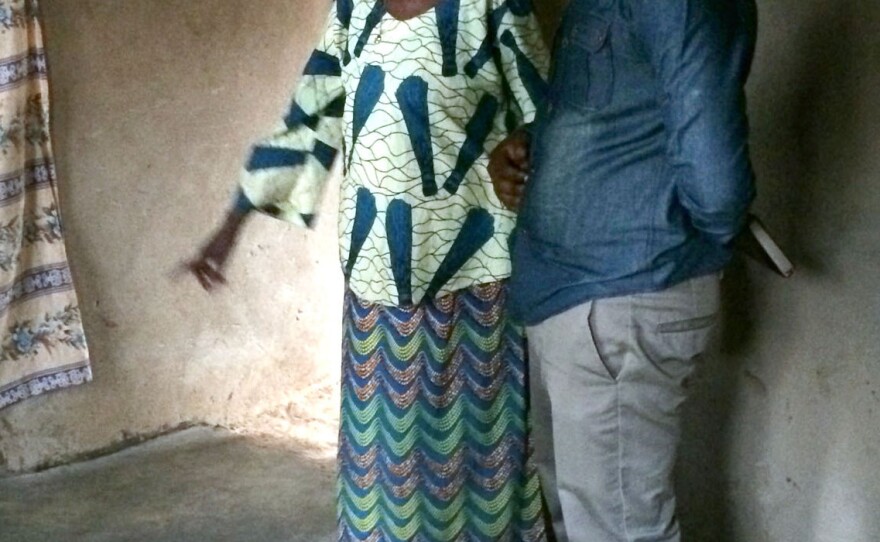 Emerence Mukakayijuka, a 72-year-old Rwandan grandmother, shows her new earthen floor to a visitor. Living without dirt floors for the first time, she marveled at the lack of dust in her home.