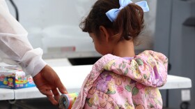 A child selects a toy after a visit to the University of Southern California's mobile dental clinic on Tuesday, July 22, 2025.