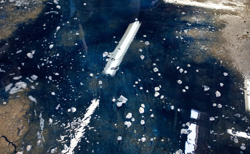 Blue dye floods the floor in the wet processing area at Blue Creations' factory in Carson, Calif.