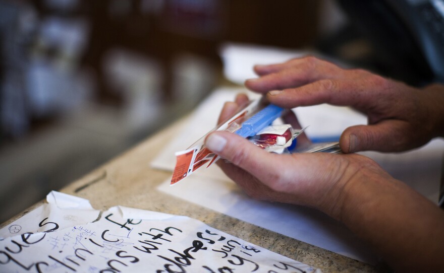 A user receives intravenous injection supplies at VANDU in Vancouver's Downtown Eastside, British Columbia.