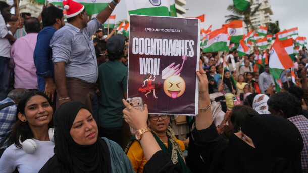 A protester holds a placard after India's Education Minister Dharmendra Pradhan resigned following nationwide protests as part of the Cockroach Janta Party's protest movement in Mumbai, India on Saturday.