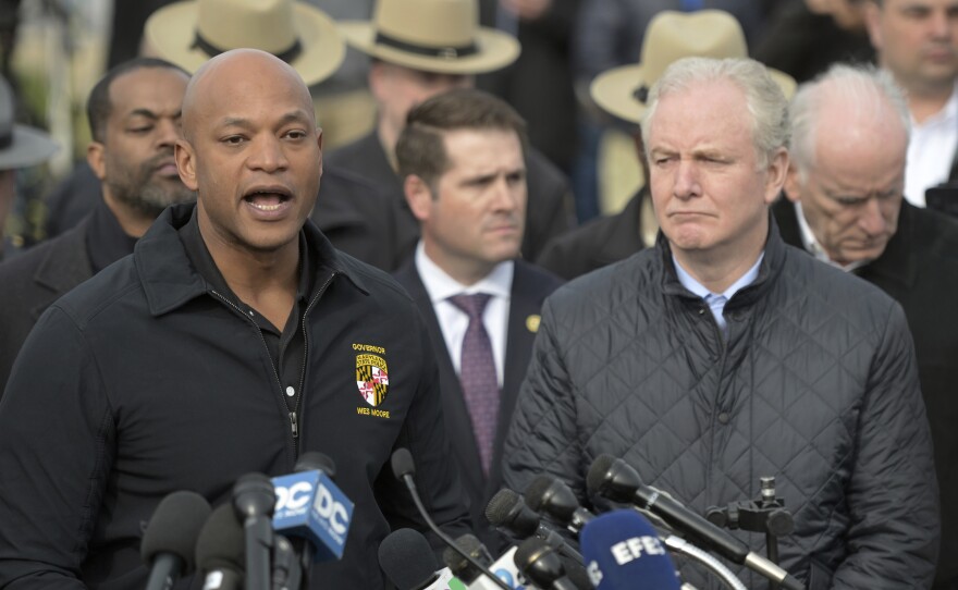 Maryland Gov. Wes Moore, left, speaks during a news conference as Sen. Chris Van Hollen (D-Md.) looks on near the scene where a container ship collided with a support on the Francis Scott Key Bridge.