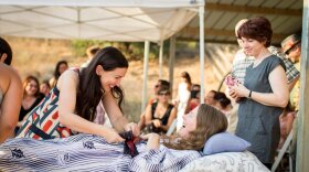 Betsy Davis, center, greets friends during her "Rebirth" party in Ojai on July 24. Davis was diagnosed with ALS. Her sister, writer Kelly Davis, looks on at right.