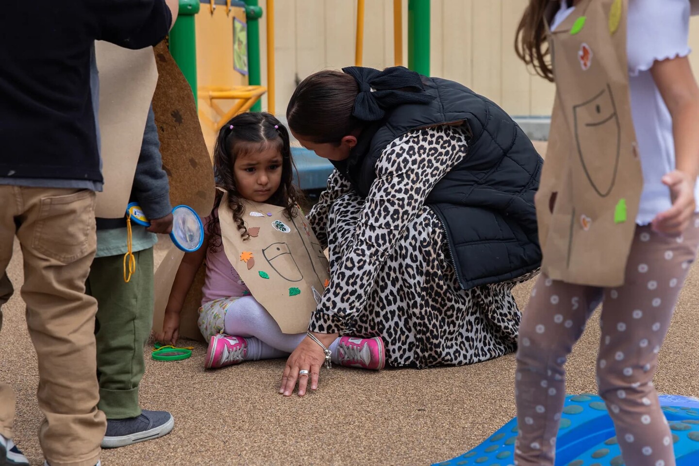 Teacher Viviana Vasquez comforts a student during a safari hunt. The preschool has eight teachers, two on-site therapists and a behavioral therapist on staff. While therapists mainly focus on the mental health of a student, behavioral therapists center on examining the actions and conduct of a student to see what may be triggering them or getting in the way of them interacting with others, taken in San Diego on April 23, 2025.