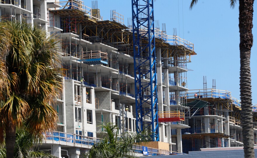 Multifamily buildings can provide single-level living, but some baby boomers are wary of paying condo fees. A mixed-use apartment development is seen under construction in St. Petersburg, Fla., in February.