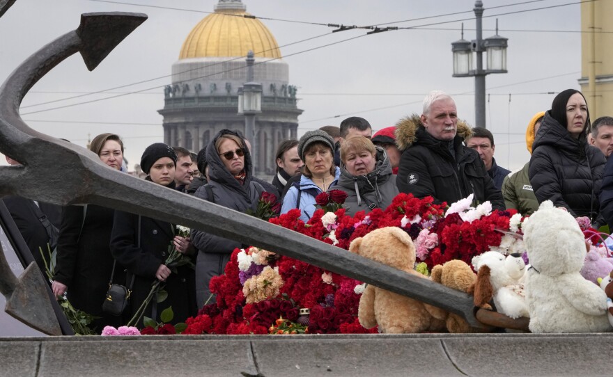 People lay flowers at a spontaneous memorial in memory of the victims of Moscow attack in St. Petersburg, Russia, on Sunday.