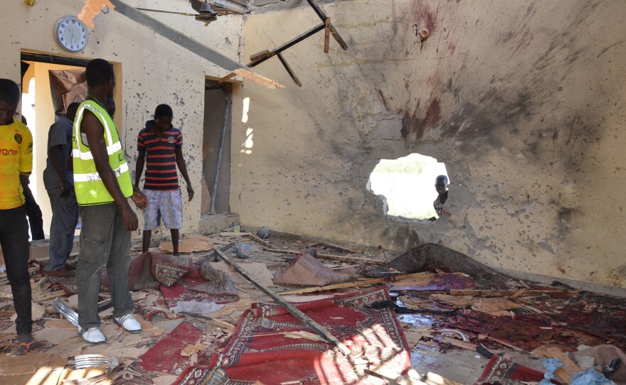People inspect a damaged mosque following an October 2015 explosion in Maiduguri, Nigeria. Maiduguri is in Borno State, where Boko Haram was born.