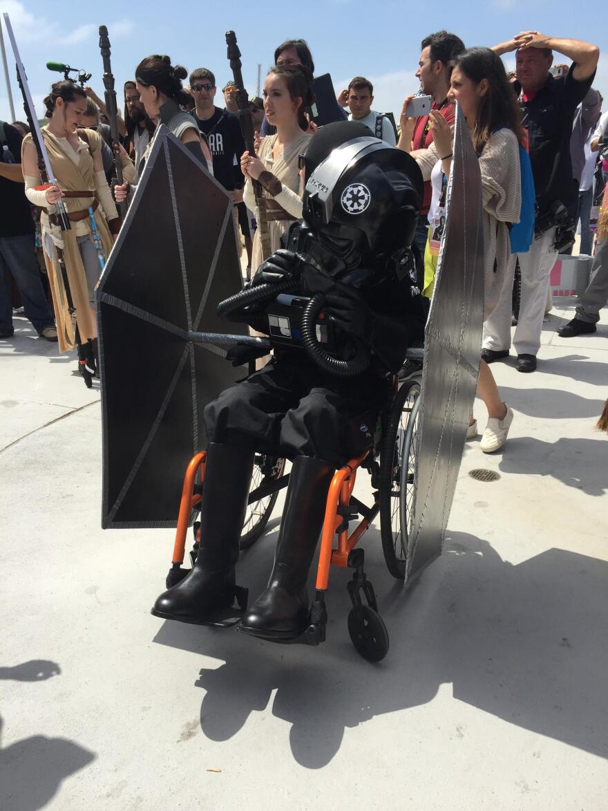 Matthew Tillyer dressed as a TIE fighter pilot in a wheel-chair converted into a TIE fighter with the help of the 501st at Comic-Con International, July 19-23, 2017.