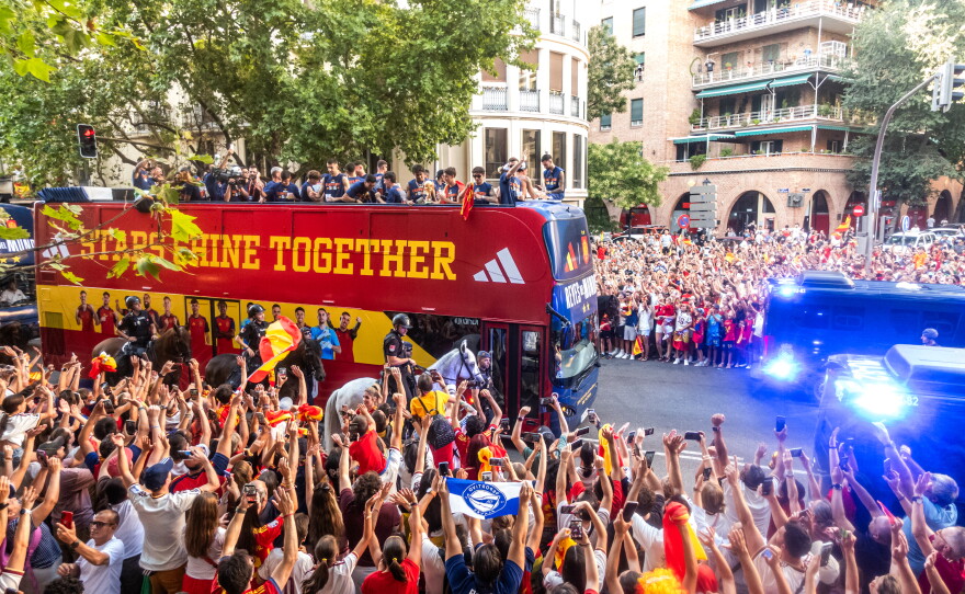 Players from Spain's national soccer team celebrate atop a bus as it travels through crowded streets in Madrid, Monday, July 20, 2026, after Spain defeated Argentina in the World Cup final in East Rutherford, N.J., near New York.