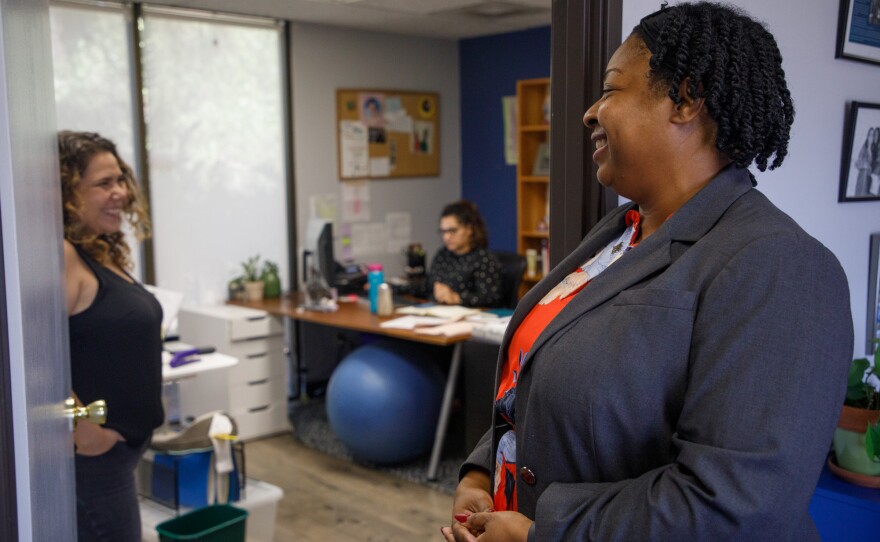 Kyra Greene, executive director at the Center on Policy Initiatives in San Diego, is photographed speaking with colleagues at the nonprofit’s offices on Aug. 13, 2019.