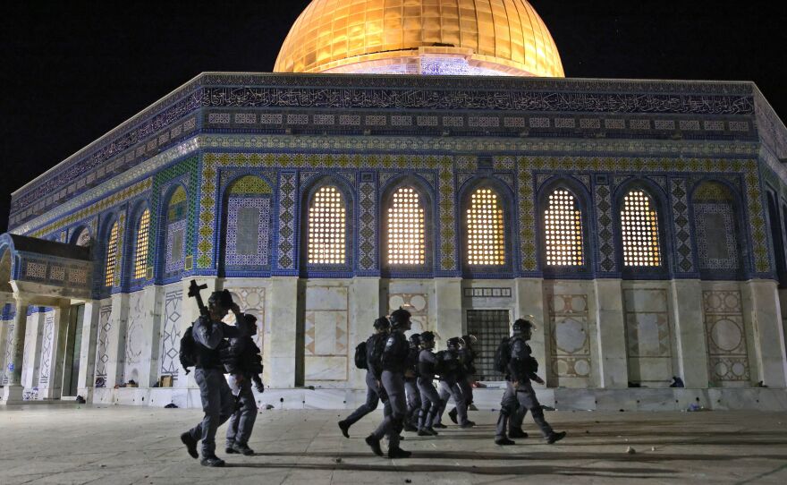 Israeli security forces deploy next to the Dome of the Rock mosque amid clashes with Palestinian protesters at the Al-Aqsa mosque compound in Jerusalem on Friday.