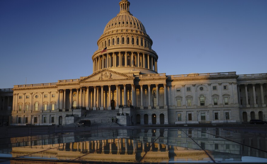 The Capitol is seen at sunrise on the first full day of the impeachment trial of President Trump on charges of abuse of power and obstruction of Congress on Tuesday.