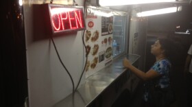 A woman orders from the Datapoint Taqueria food truck in San Antonio.