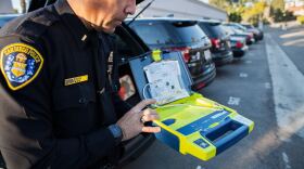 Northeastern Division Acting Captain Charles Lara shows one of the portable defibrillators kept in patrol cars. The devices were purchased with funding from the Community Projects, Programs and Services fund. Feb. 2, 2017.