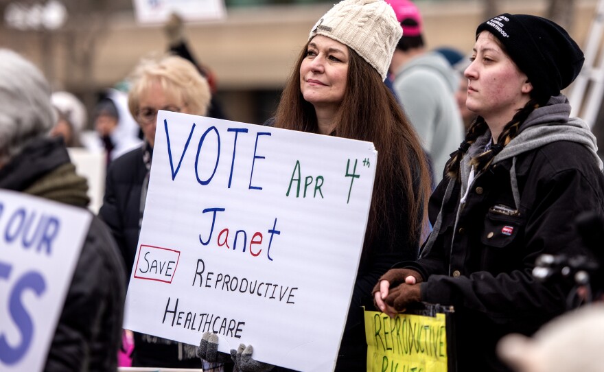 Melissa Johnson holds a sign in support of Wisconsin state supreme court candidate Judge Janet Protasiewicz during a rally Saturday, March 11, 2023, in Appleton, Wis.