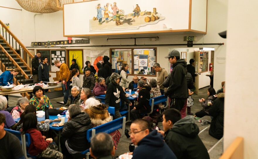 People eat Yup'ik food at a potluck held for the census kick-off ceremony in Toksook Bay.