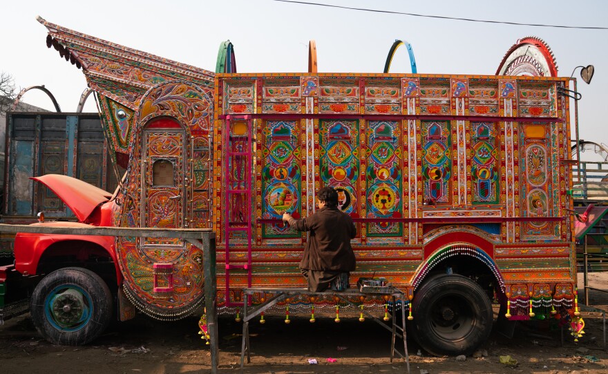 Painter Irfan Mohammad works on a truck at a sprawling workshop in Rawalpindi, Pakistan.