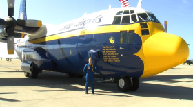 Katie Higgins, the first female pilot of the Navy's Blue Angels, stands by the C130 cargo plane at MCAS Miramar, Oct. 1, 2015.