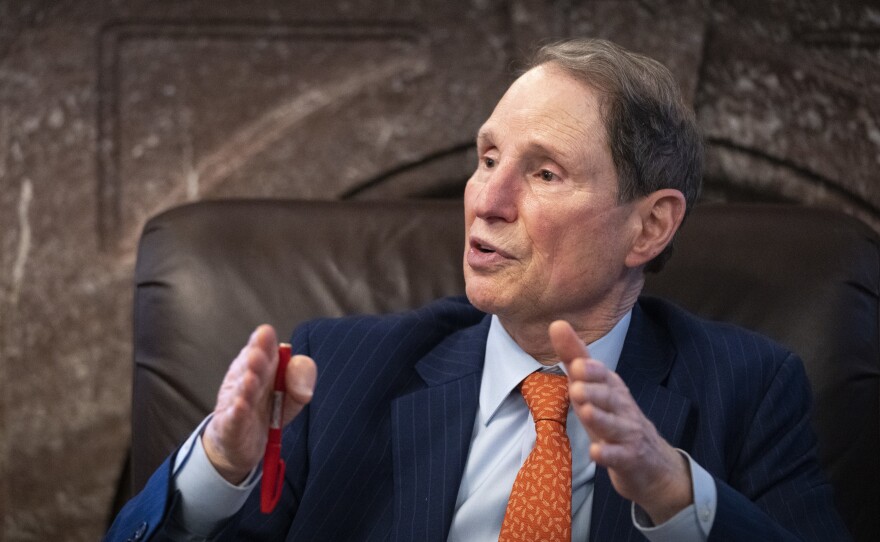 Sen. Ron Wyden, D-Oregon, speaks to reporters about a corporate minimum tax plan at the U.S. Capitol on Oct. 26 in Washington, D.C. Wyden feuded with Tesla CEO Elon Musk over the senator's proposal to tax stock investments held by billionaires annually.