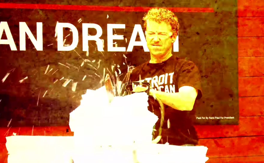 In a campaign video, Rand Paul uses a chainsaw to shred 1,700 pages of what he says represents the federal tax code. Paul is offering a flat-tax plan that fits on one page.