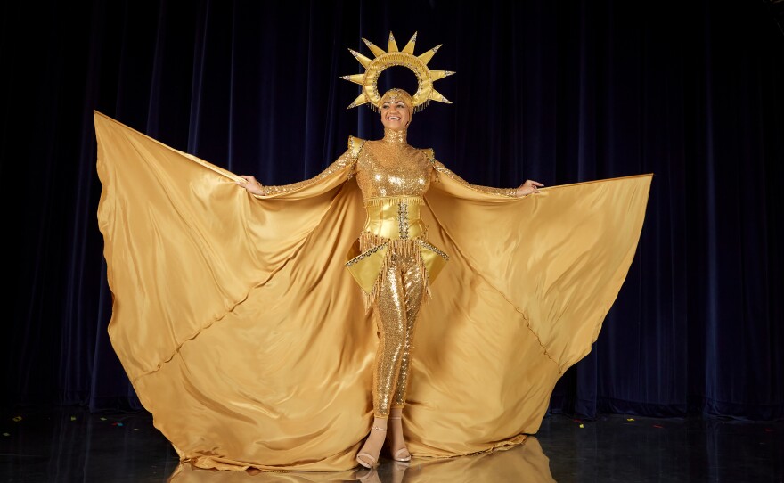 Miss South Africa, Chedino Rodriguez Martin, poses in her national costume. The costume, a golden body suit with a sun crown and cape, paid homage to South Africa's illegal mine workers.