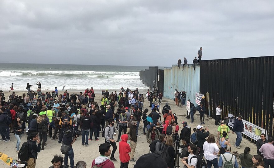 A caravan of asylum seekers and their supporters rally at the U.S.-Mexico border fence, April 29, 2018. 