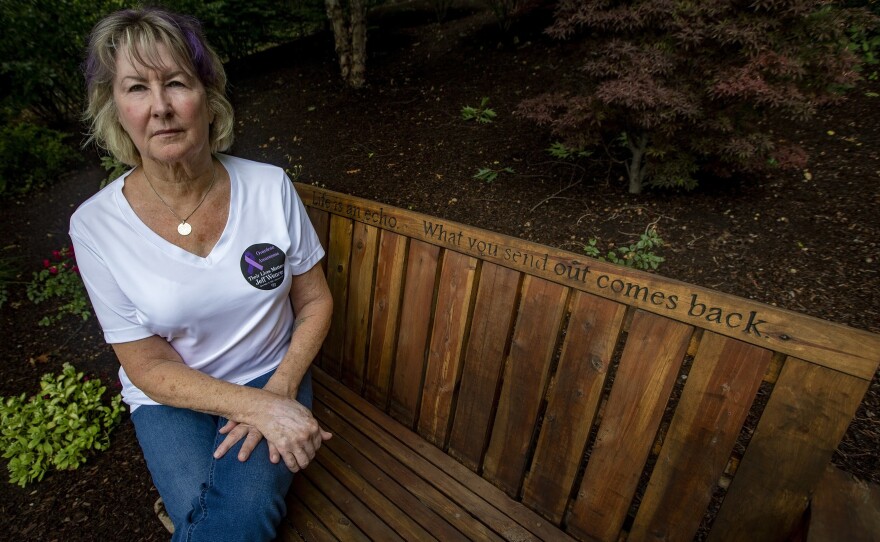 Lynn Wencus sits on a bench in her backyard dedicated to her son Jeff, whom she lost to an opioid overdose in 2017. She is one of many people filing an individual claim in the Purdue Pharma settlement.