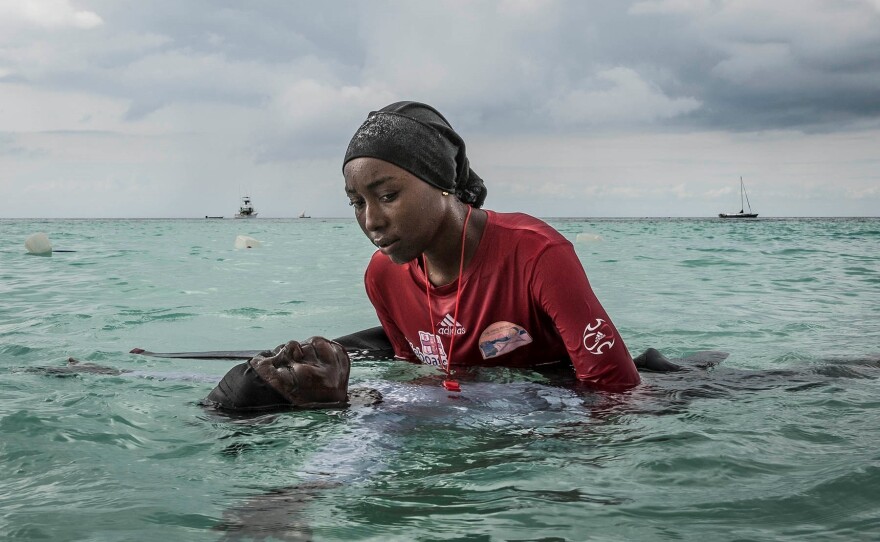 A swim instructor named Siti, 24, helps a girl learn to float on Nov. 17, 2016. "By encouraging long-term cultural change — the acceptance of women learning to swim in an Islamic community — Anna Boyiazis's project<em> Finding Freedom in the Water</em> could literally save lives, said Leica photo contest judge and former <em>National Geographic</em> photo editor Elizabeth Krist.