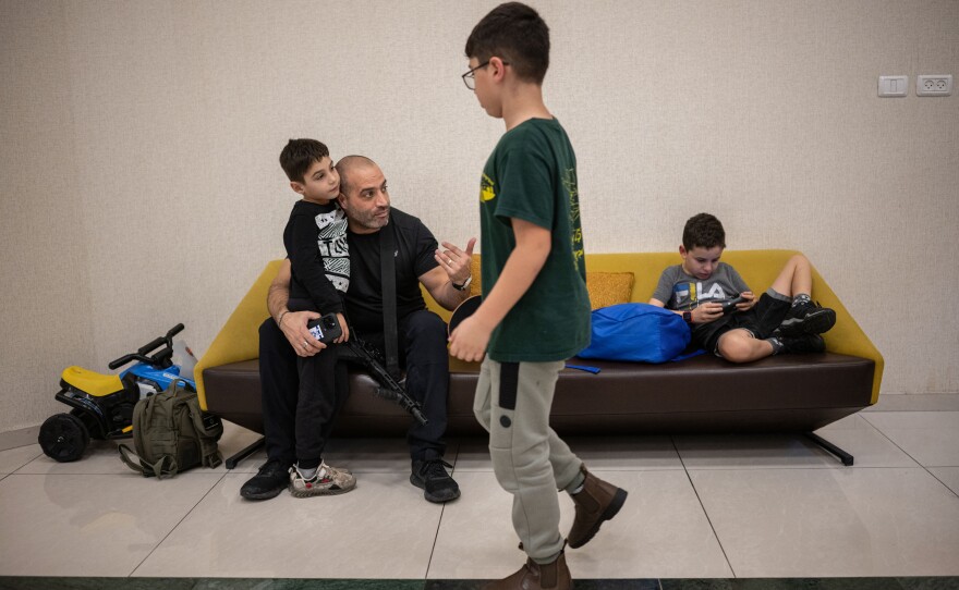Michel Fajima talks with his son Oria Fajima, 6, at the Ramada Hotel in Nazareth, Israel, where they have been living since being evacuated from Snir, their kibbutz in northern Israel located a few kilometers from the border with Lebanon, on Nov. 28.