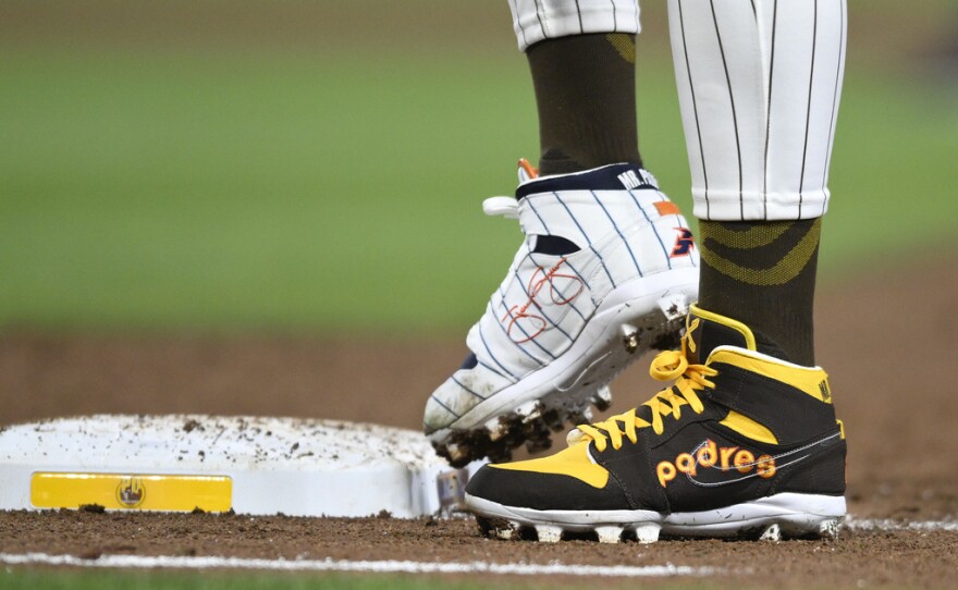 San Diego Padres' Fernando Tatis Jr. (23) wears cleats commemorating the Padres's 1980's and 1990's teams during a baseball game against the Chicago Cubs, Monday, April 8, 2024, in San Diego. Tatis plans to unveil 50 pairs of custom cleats this season in conjunction with his branding company, Xample, and Los Angeles-based Shoe Surgeon. The cleats will honor people, events and whatever strikes the 25-year-old Tatis' fancy.