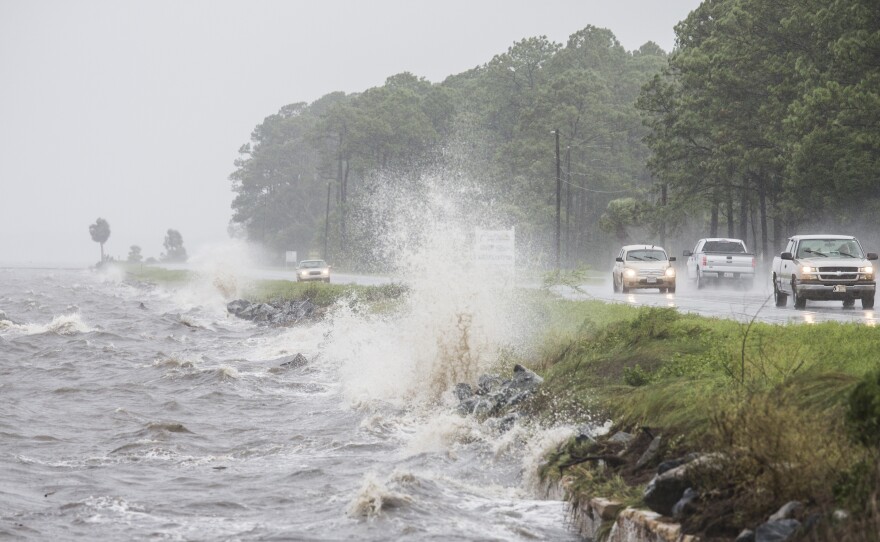 Traffic moves along U.S. Highway 98 in Eastpoint, Fla., ahead of Hermine, which made landfall early Friday.