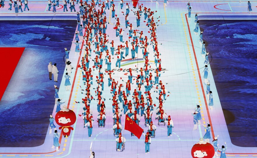 Flag bearers Yujie Guo and Zhidong Wang of Team China lead their team out during the Opening Ceremony of the Beijing 2022 Winter Paralympics.