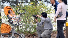 A South Korean man takes a photo of his baby during a picnic in Seoul, in 2009. After years of promoting family planning, South Korea is seeing unprecedented numbers of women staying single into their 30s — up from a handful a generation ago to 40 percent.