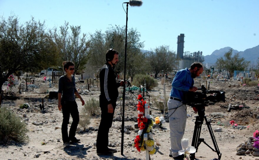 Patricia Benabe, José "Inerzia" Longás and Claudio Rocha follow journalist Sergio Haro on assignment at a municipal graveyard in Mexicali, Mexico.