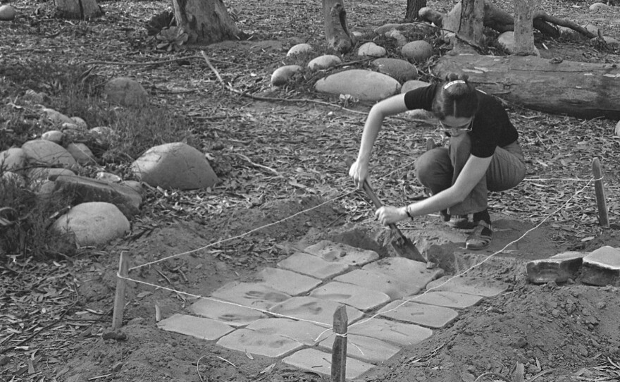 UCSD graduate student Virginia Maksymowicz installing her anonymous sculpture "Thirty Blocks" in 1976. Photo by Blaise Tobia.