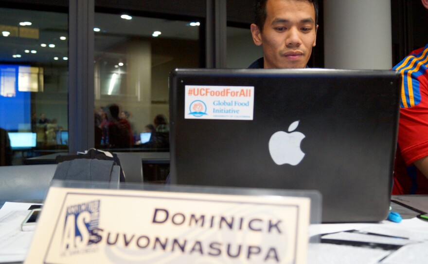 UC San Diego Associated Students President Dominick Suvonnasupa checks his computer after Wednesday's unanimous council vote, Jan. 27, 2016.