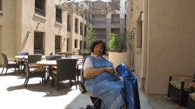 Resident Anita Estes sits in the courtyard of the new, eco-friendly Courtyard Terraces in City Heights, May 20, 2010.
