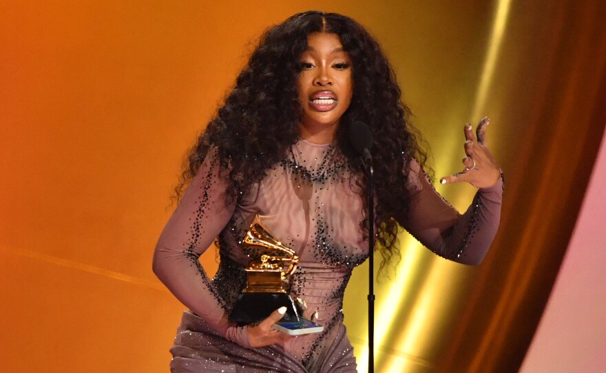 SZA accepts the best R&B song award for "Snooze" on stage during the 66th Annual Grammy Awards.